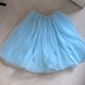 Long ballet tutu in blue with 4 layers of veil. Calf length with ribbon ties